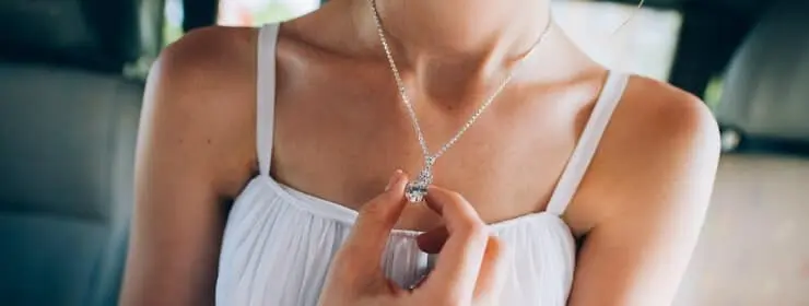 A woman shows off her necklace