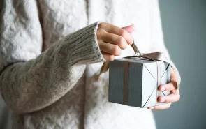 woman holding a holiday gift that she got