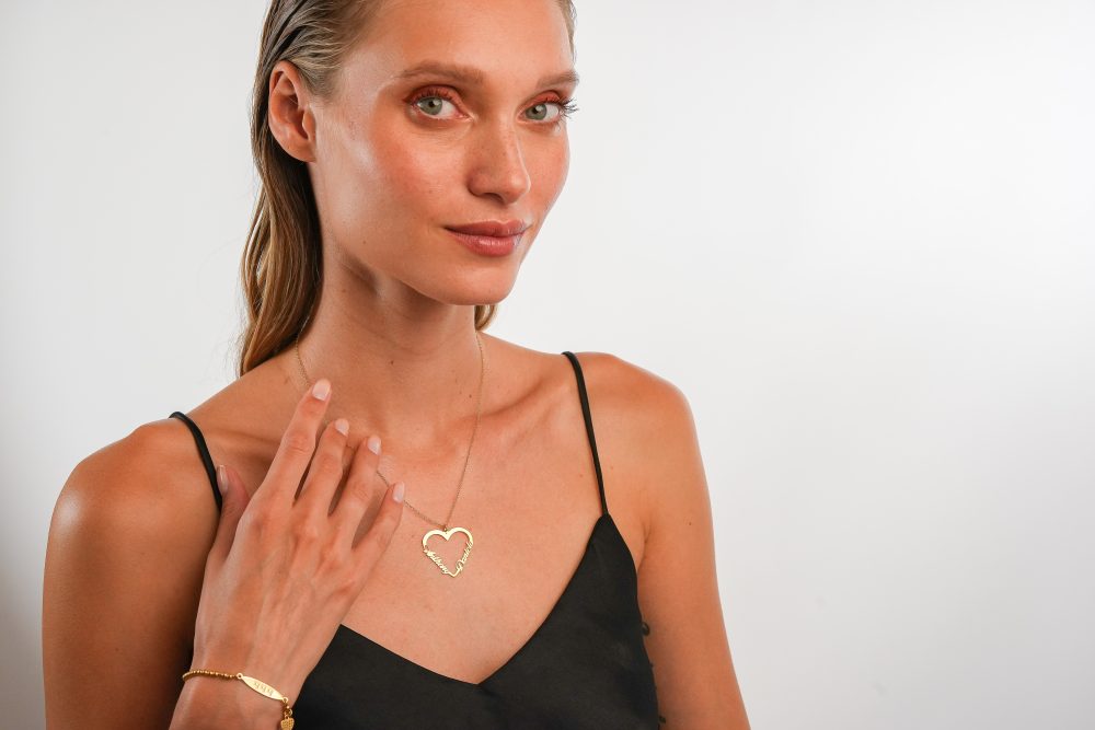 Couple heart name necklace on model gold
