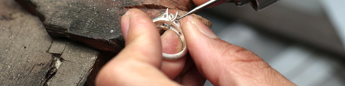 a man holding ring in a jewelry factory