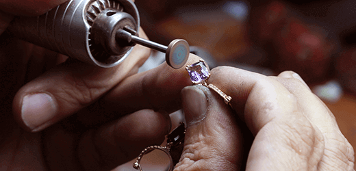A man at the factory polishing a ring