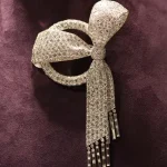 Elizabeth Taylor Art Deco Diamond Bow Brooch by Van Cleef & Arpels, auctioned by Christie's